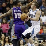 Minnesota Timberwolves' J.J. Barea, right, lays up for two of his 16 points off the bench in the second half of an NBA basketball game as Phoenix Suns' Marcus Morris defends on Saturday, April 13, 2013, in Minneapolis. The Timberwolves won 105-93. (AP Photo/Jim Mone)