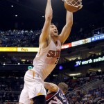 
Phoenix Suns' Miles Plumlee dunks over Atlanta Hawks' Kyle Korver (26) during the second half of an NBA basketball game, Sunday, March 2, 2014, in Phoenix. The Suns won 129-120. (AP Photo/Matt York)