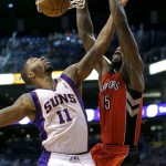 Toronto Raptors' Amir Johnson (15) dunks over Phoenix Suns' Markieff Morris (11) during the first half of an NBA basketball game, Wednesday, March 6, 2013, in Phoenix. (AP Photo/Matt York)