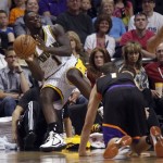 Indiana Pacers guard Lance Stephenson, left, throws the ball into play as he tumbles out out bounds and Phoenix Suns guard Goran Dragic, right, of Slovenia, looks on during the first half of an NBA basketball game Saturday, March 30, 21013, in Phoenix. (AP Photo/Paul Connors)