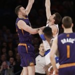 Phoenix Suns' Miles Plumlee (22) shoots over New York Knicks' Andrea Bargnani (77) during the first half of an NBA basketball game, Monday, Jan. 13, 2014, in New York. (AP Photo/Frank Franklin II)