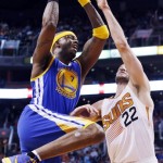  Golden State Warriors' Jermaine O'Neal (7) drives past Phoenix Suns' Miles Plumlee (22) to score during the first half of an NBA basketball game Saturday, Feb. 8, 2014, in Phoenix. (AP Photo/Ross D. Franklin)