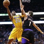 Los Angeles Lakers' Jodie Meeks (20) goes up for a shot against Phoenix Suns' Goran Dragic (1), of Slovenia, in the first half of an NBA basketball game on Monday, March 18, 2013, in Phoenix. (AP Photo/Ross D. Franklin)