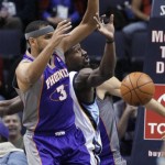 Memphis Grizzlies' Tony Allen, center, passes the ball around Phoenix Suns' Jared Dudley (3) during the first half of an NBA basketball game in Memphis, Tenn., Tuesday, Feb. 5, 2013. (AP Photo/Danny Johnston)