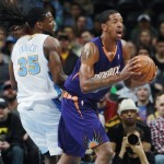 Phoenix Suns forward Channing Frye, front, pulls in loose ball in front of Denver Nuggets forward Kenneth Faried during the first quarter of an NBA basketball game in Denver on Tuesday, Feb. 18, 2014. (AP Photo/David Zalubowski)
