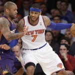 New York Knicks' Carmelo Anthony (7) is defended by Phoenix Suns' P.J. Tucker (17) during the overtime period of an NBA basketball game Monday, Jan. 13, 2014, in New York. The Knicks won the game 98-96. (AP Photo/Frank Franklin II)