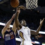 New Orleans Pelicans small forward Al-Farouq Aminu (0) battles for a rebound with Phoenix Suns power forward Miles Plumlee (22) in the first half of an NBA basketball game in New Orleans, Tuesday, Nov. 5, 2013. (AP Photo/Gerald Herbert)