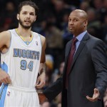 Denver Nuggets guard Evan Fournier, left, oconfers with coach Brian Shaw during a timeout in the first quarter of an NBA basketball game against the Phoenix Suns in Denver on Tuesday, Feb. 18, 2014. (AP Photo/David Zalubowski)
