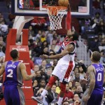 Washington Wizards guard John Wall, center, goes to the basket against Phoenix Suns forward Michael Beasley (0) and Wesley Johnson, left, during the first half of an NBA basketball game on Saturday, March 16, 2013, in Washington. (AP Photo/Nick Wass)
