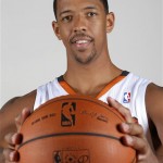Phoenix Suns' Channing Frye holds a basketball as he poses for a photograph during the team's NBA basketball media day on Monday, Sept. 30, 2013, in Phoenix. The Suns announced that Frye has been cleared to join the team's training camp, a year after it was found that Frye would have to miss the entire basketball season because of an enlarged heart. (AP Photo/Ross D. Franklin)