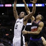 San Antonio Spurs' Kawhi Leonard (2) drives to the basket as Phoenix Suns' Wesley Johnson, right, defends during the first half of an NBA basketball game, Wednesday, Feb. 27, 2013, in San Antonio. (AP Photo/Eric Gay)