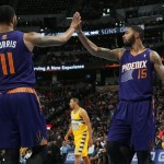 Phoenix Suns forwards Markieff Morris, left, and Marcus Morris congratulated each other after stopping the Denver Nuggets as they drove for a shot in the third quarter of the Suns' 103-99 victory in an NBA basketball game in Denver on Friday, Dec. 20, 2013. (AP Photo/David Zalubowski)