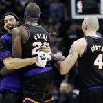 Phoenix Suns' Jermaine O'Neal (20) celebrates with teammates Luis Scola, left, and Marcin Gortat (4) after winning their NBA basketball game against the San Antonio Spurs, Wednesday, Feb. 27, 2013, in San Antonio. The Suns won 105-101 in overtime. (AP Photo/Eric Gay)