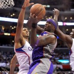 Los Angeles Clippers center Ryan Hollins, left, and forward Lamar Odom, right, defend as Phoenix Suns center Jermaine O'Neal tries to put up a shot in the first half of an NBA basketball game in Los Angeles on Wednesday, April 3, 2013. (AP Photo/Richard Hartog)