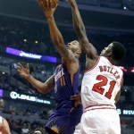 Phoenix Suns forward Markieff Morris (11) shoots past Chicago Bulls guard Jimmy Butler (21) during the first half of an NBA basketball game, Tuesday, Jan. 7, 2014, in Chicago. (AP Photo/Charles Rex Arbogast)