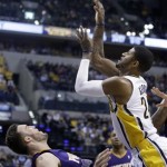 Indiana Pacers forward Paul George, right, is fouled by Phoenix Suns center Miles Plumlee while shooting in the second half of an NBA basketball game in Indianapolis, Thursday, Jan. 30, 2014. The Suns defeated the Pacers 102-94. (AP Photo)