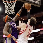 Houston Rockets center Omer Asik (3) has his shot attempt blocked by Phoenix Suns center Jermaine O'Neal (20) during the second half of an NBA basketball game Tuesday, April 9, 2013, in Houston. Houston won 101-98. (AP Photo/Bob Levey)