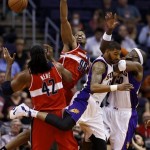 Washington Wizards' Nene (42) and Jason Collins (98) battle Phoenix Suns' Markiff Morris and Jermaine O'Neal, right, for the ball during the first half of an NBA basketball game on Wednesday, March 20, 2013, in Phoenix. (AP Photo/Matt York)