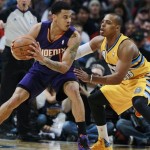 Phoenix Suns guard Gerald Green, left, looks to pass the ball as Denver Nuggets guard Randy Foye covers in the fourth quarter of the Suns' 103-102 victory in an NBA basketball game in Denver on Friday, Dec. 20, 2013. (AP Photo/David Zalubowski)
