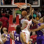 Houston Rockets forward Greg Smith (4) dunks on Phoenix Suns forwards Wesley Johnson (2) and Luis Scola (14) during the first half of an NBA basketball game Tuesday, April 9, 2013, in Houston. (AP Photo/Bob Levey)