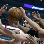 Chicago Bulls center Joakim Noah battles multiple players for a rebound during the second half of an NBA basketball game against the Phoenix Suns, Tuesday, Jan. 7, 2014, in Chicago. The Bulls won 92-87. (AP Photo/Charles Rex Arbogast)