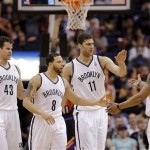 Brooklyn Nets' Kris Humphries (43), Deron Williams (8), Brook Lopez (11) and Keith Bogans (10) celebrate against the Phoenix Suns during the second half of an NBA basketball game, Sunday, March 24, 2013, in Phoenix. The Nets won 102-100.(AP Photo/Matt York)
