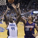 Orlando Magic's Andrew Nicholson (44) and Phoenix Suns' Channing Frye (8) go after a rebound during the second half of an NBA basketball game in Orlando, Fla., Sunday, Nov. 24, 2013. Phoenix Suns won 104-96. (AP Photo/John Raoux)