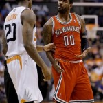 Phoenix Suns' Archie Goodwin and Milwaukee Bucks' O.J. Mayo (00) are separated by the referee during the second half of an NBA basketball game, Saturday, Jan. 4, 2014, in Phoenix. The Suns won 116-100. (AP Photo/Matt York)