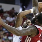 Phoenix Suns' Markieff Morris, left, shoots against Miami Heat's Damion James in the first quarter of an NBA Summer League basketball game, Sunday, July 21, 2013, in Las Vegas. (AP Photo/Julie Jacobson)
