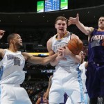 Denver Nuggets center Timofey Mozgov, center, of Russia, tries to pull down a rebound in front of forward Anthony Randolph, left, while Phoenix Suns center Alex Len reaches for the ball during the first quarter of an NBA basketball game in Denver on Tuesday, Feb. 18, 2014. (AP Photo/David Zalubowski)
