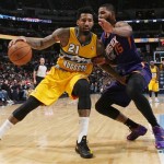 Denver Nuggets forward Wilson Chandler, left, works ball inside as Phoenix Suns forward Marcus Morris covers in the third quarter of the Suns' 103-99 victory in an NBA basketball game in Denver on Friday, Dec. 20, 2013. (AP Photo/David Zalubowski)