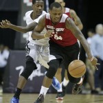 Miami Heat's James Nunnally, right, steals the ball from Phoenix Suns' Archie Goodwin in the fourth quarter of an NBA Summer League basketball game on Sunday, July 21, 2013, in Las Vegas. (AP Photo/Julie Jacobson)