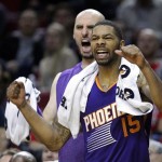 The Phoenix Suns' Marcus Morris, right, and Marcin Gortat cheer from the bench during the second half of an NBA preseason basketball game against the Portland Trail Blazers in Portland, Ore., Wednesday, Oct. 9, 2013. The Suns won 104-98. (AP Photo/Don Ryan)