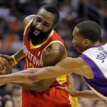 Houston Rockets' James Harden (12) protects the ball as Phoenix Suns' Wesley Johnson (2) reaches during the first half of an NBA basketball game, Monday, April 15, 2013, in Phoenix. (AP Photo/Matt York)