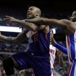 Phoenix Suns forward P.J. Tucker (17) is fouled by Detroit Pistons center Greg Monroe (10) while driving to the basket during the first half of an NBA basketball game, Saturday, Jan. 11, 2014, in Auburn Hills, Mich. (AP Photo/Duane Burleson)