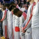 Houston Rockets players observe a moment of silence for the victims of the Boston Marathon explosions before an NBA basketball game against the Phoenix Suns, Monday, April 15, 2013 in Phoenix. (AP Photo/Matt York)