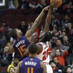 Phoenix Suns forward Marcus Morris (15) blocks the shot of Chicago Bulls forward Tony Snell (20) as Markieff Morris (11) watches during the first half of an NBA basketball game, Tuesday, Jan. 7, 2014, in Chicago. (AP Photo/Charles Rex Arbogast)
