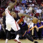 Phoenix Suns' Michael Beasley (0) tries to drive past Houston Rockets' Thomas Robinson during the second quarter of an NBA basketball game Wednesday, March 13, 2013, in Houston. (AP Photo/David J. Phillip)