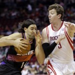 Phoenix Suns' Luis Scola (14) tries to drive past Houston Rockets' Omer Asik (3) during the first quarter of an NBA basketball game Wednesday, March 13, 2013, in Houston. (AP Photo/David J. Phillip)
