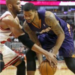 Chicago Bulls forward Taj Gibson, left, pressures Phoenix Suns power Markieff Morris during the first half of an NBA basketball game, Tuesday, Jan. 7, 2014, in Chicago. (AP Photo/Charles Rex Arbogast)