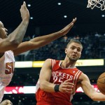 Houston Rockets forward Chandler Parsons (25) drives on Phoenix Suns forward Channing Frye (8) in the second quarter of an NBA basketball game, Sunday, Feb. 23, 2014, in Phoenix. (AP Photo/Rick Scuteri)