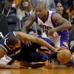 Atlanta Hawks' Al Horford, front, and Phoenix Suns' P.J. Tucker battle for a loose ball during the first half of an NBA basketball game, Friday, March 1, 2013, in Phoenix. (AP Photo/Matt York)