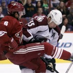 Phoenix Coyotes defenseman David Schlemko, left, is checked by Colorado Avalanche left winger Cody McLeod, right, in the first period of NHL hockey game, Saturday, April 6, 2013, in Glendale, Ariz. (AP Photo/Paul Connors)
