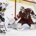 Phoenix Coyotes' Mike Smith (41) makes a save on a rebound shot by Chicago Blackhawks' Jonathan Toews (19) during the second period in an NHL hockey game, Friday Feb. 7, 2014, in Glendale, Ariz. (AP Photo/Ross D. Franklin)