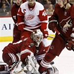 Phoenix Coyotes' Chad Johnson, left, makes a save on a shot as Detroit Red Wings' Henrik Zetterberg (40), of Sweden, and Coyotes' Radim Vrbata (17), of the Czech Republic, and Oliver Ekman-Larsson (23), of Sweden, all watch during the first period pf an NHL hockey game Thursday, April 4, 2013, in Glendale, Ariz. (AP Photo/Ross D. Franklin)