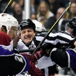 A referee attempts to break up a skirmish between Phoenix Coyotes and Los Angeles Kings players after a near-miss at the net during the first period of an NHL hockey game, Monday, March 18, 2013, in Los Angeles. (AP Photo/Gus Ruelas)