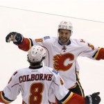Calgary Flames' Joe Colborne (8) celebrates his goal against the Phoenix Coyotes with teammate T.J. Galiardi (39) during the third period of an NHL hockey game on Tuesday Oct. 22, 2013, in Glendale, Ariz. The Coyotes defeated the Flames 4-2. (AP Photo/Ross D. Franklin)
