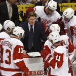 Detroit Red Wings head coach Mike Babcock, middle, talks to his players during a timeout in the third period during an NHL hockey game against the Phoenix Coyotes on Thursday, April 4, 2013, in Glendale, Ariz. The Coyotes defeated the Red Wings 4-2. (AP Photo/Ross D. Franklin)