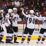  Colorado Avalanche's John Mitchell, center, celebrates his goal against the Phoenix Coyotes with teammates Nathan MacKinnon (29), Andre Benoit (61), P.A. Parenteau, right, during the second period of an NHL hockey game Thursday, Nov. 21, 2013, in Glendale, Ariz. (AP Photo/Ross D. Franklin)