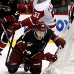 Detroit Red Wings' Valtteri Filppula (51), of Finland, trips up Phoenix Coyotes' Michael Stone (29) as Coyotes' Antoine Vermette watches in the first period during an NHL hockey game, Monday, March 25, 2013, in Glendale, Ariz. (AP Photo/Ross D. Franklin)